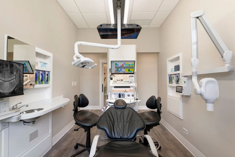 Wide view of a modern dental treatment room with a dental chair