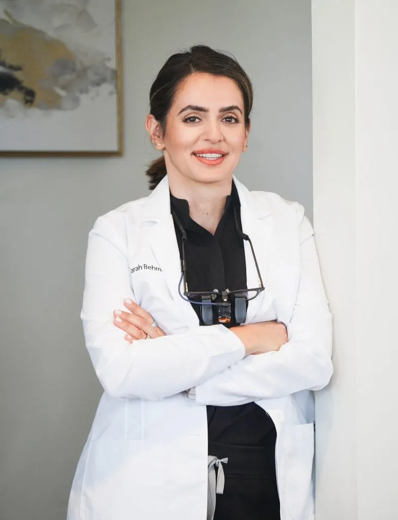 Dentist in clinical attire — representative portrait placeholder