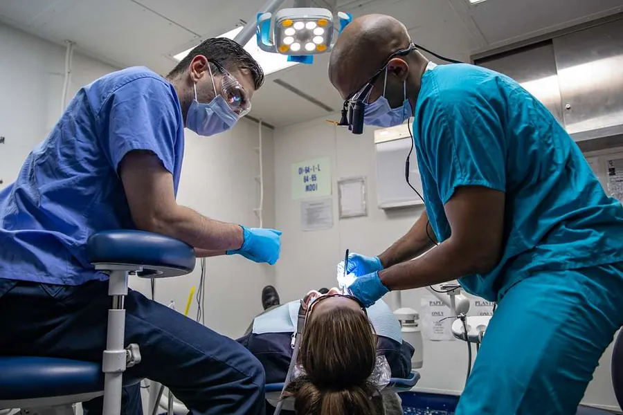 Dental professional caring for a patient during treatment